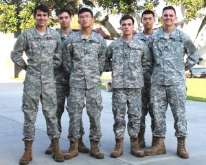Six Army and Navy Academy cadets in camouflage ACUs pose together as 11th grade class officers on campus.