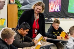 boys reading with their teacher