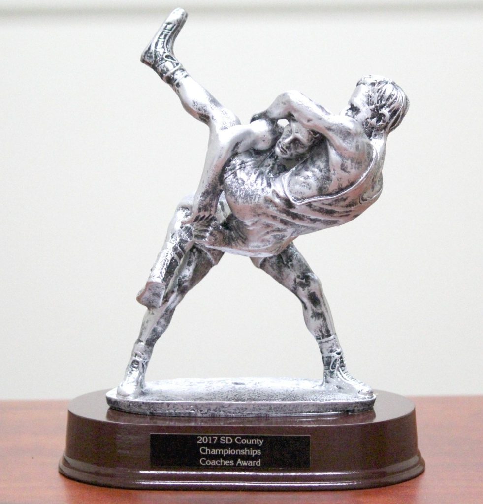 The 2017 San Diego County Wrestling Championships Coaches Award trophy, a silver figurine of two wrestlers on a wood base.