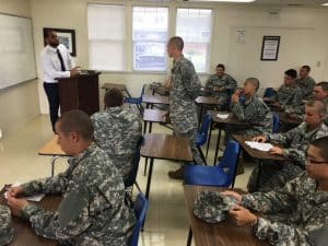 An instructor teaches a classroom of cadets in camouflage uniforms at Army and Navy Academy.
