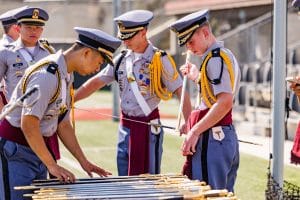 four students preparing ceremonial swords