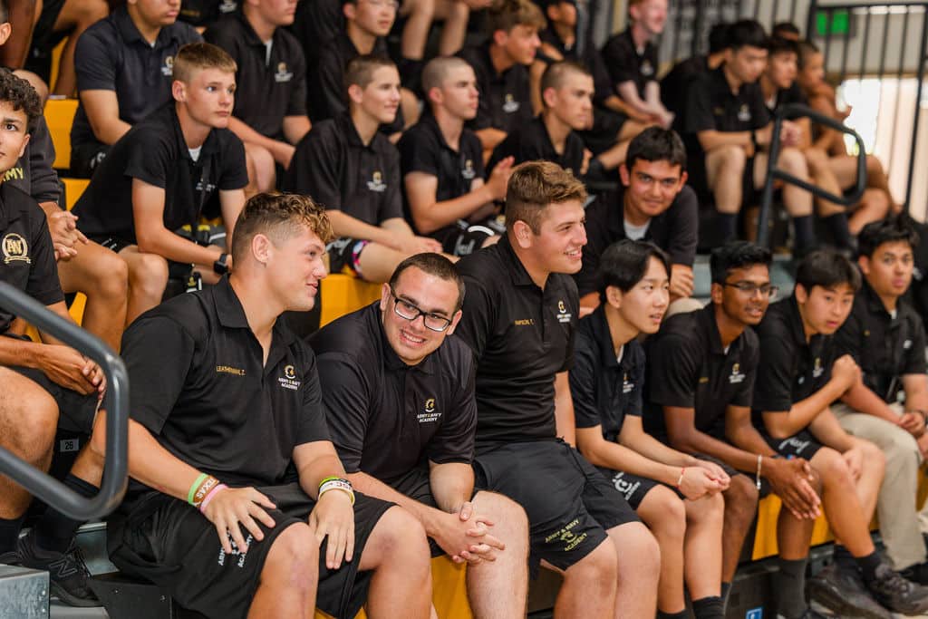 Army and Navy Academy cadets in uniform stand together on campus.