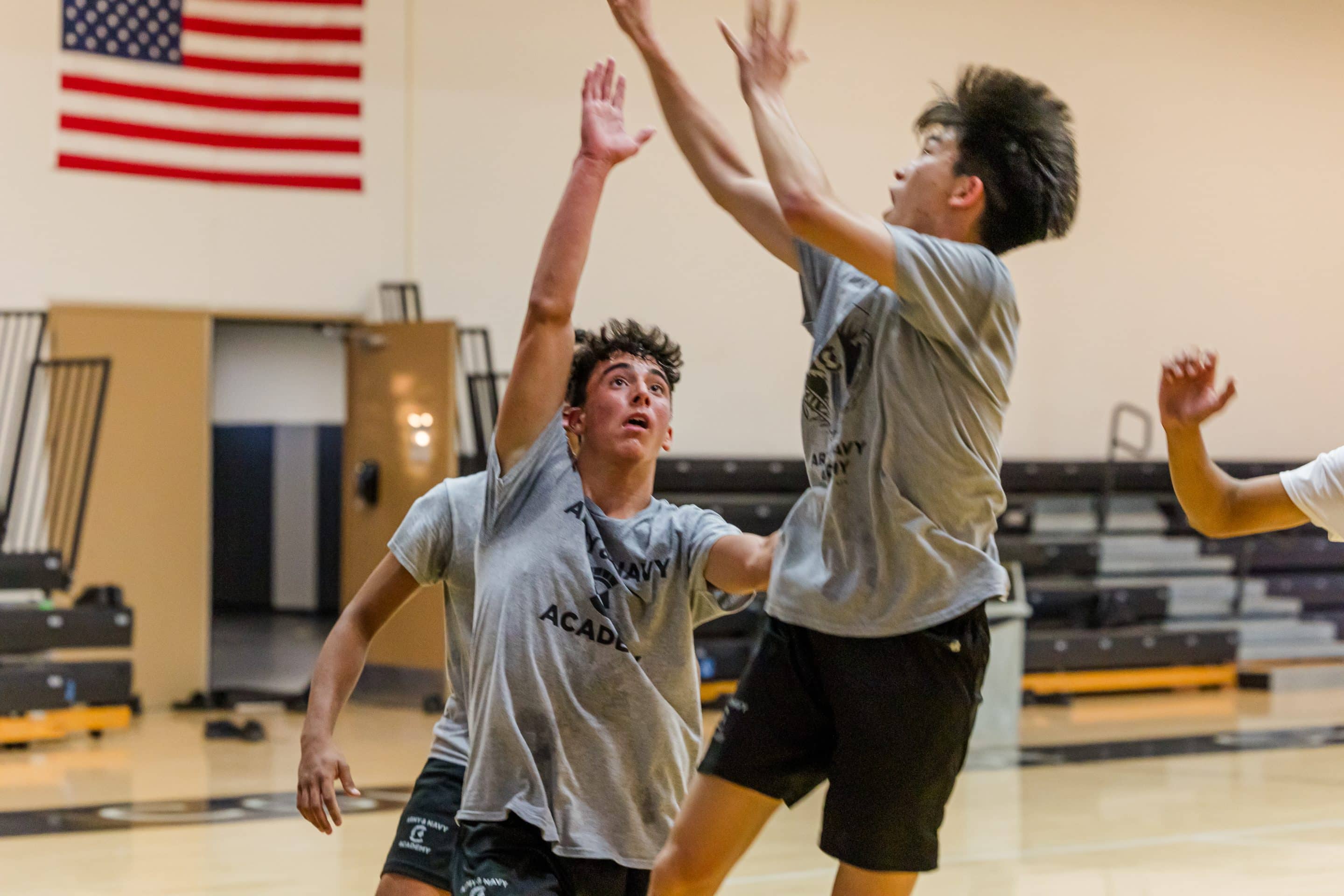 Two Army and Navy Academy cadets practice basketball in the campus gymnasium.