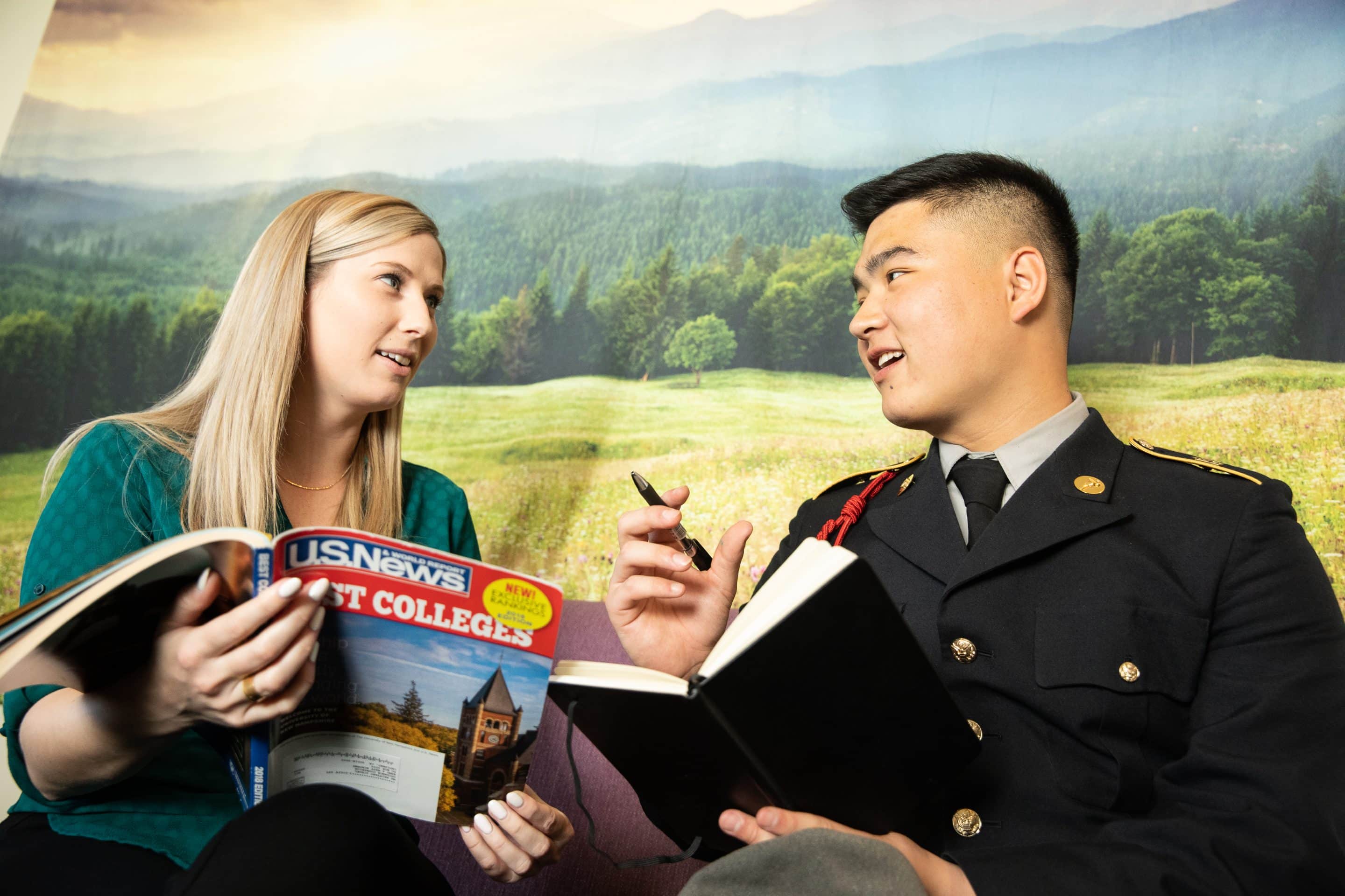 An Army and Navy Academy college counselor reviews a U.S. News Best Colleges guide with a cadet in dress uniform.