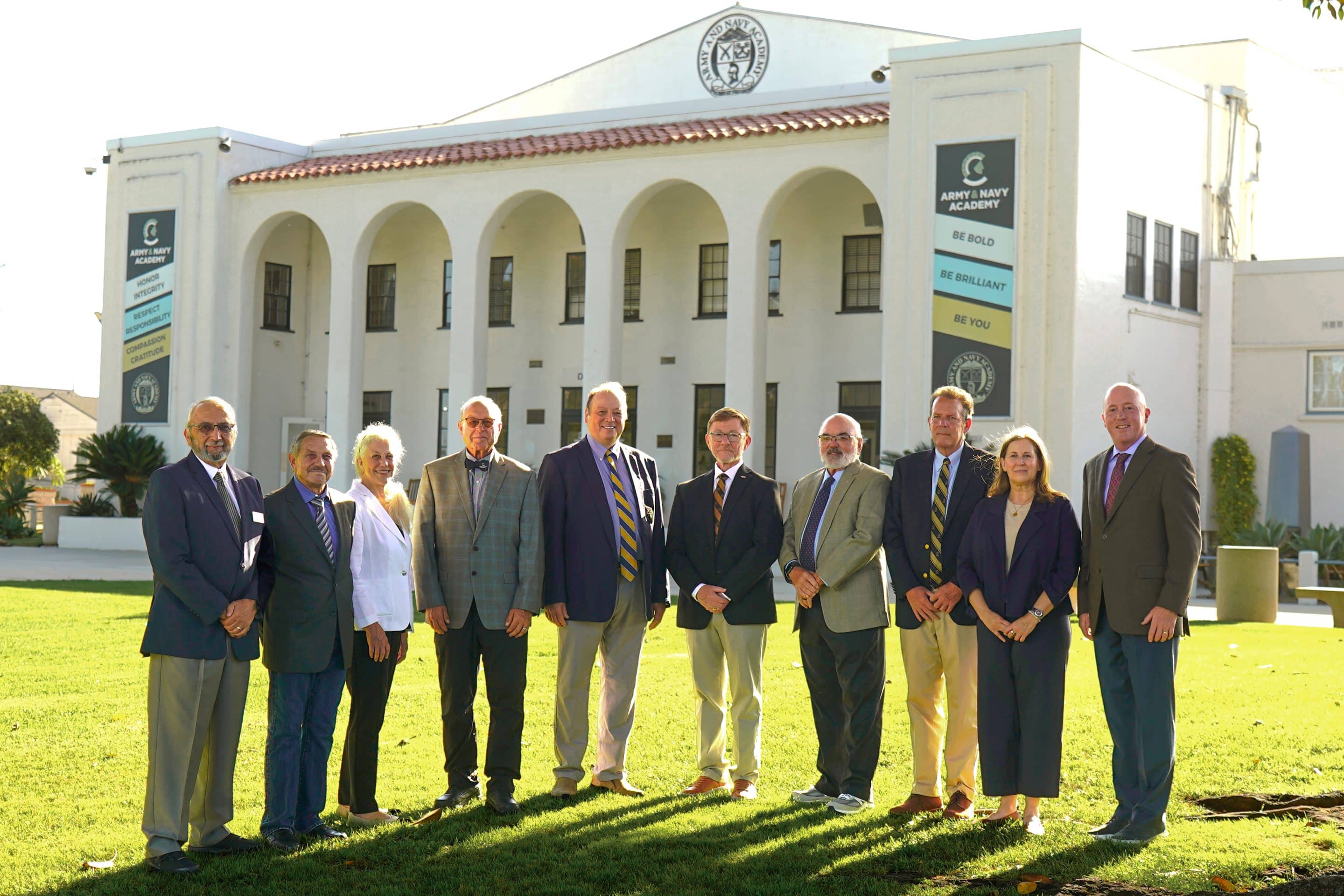 Army and Navy Academy Board of Trustees poses together under the campus entrance arch in Carlsbad, California.